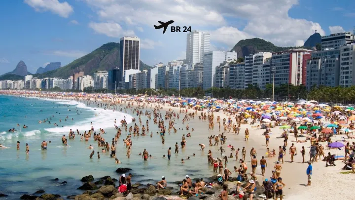 Praia de Copacabana no Rio de Janeiro cheia de turistas e vista da orla com prédios ao fundo