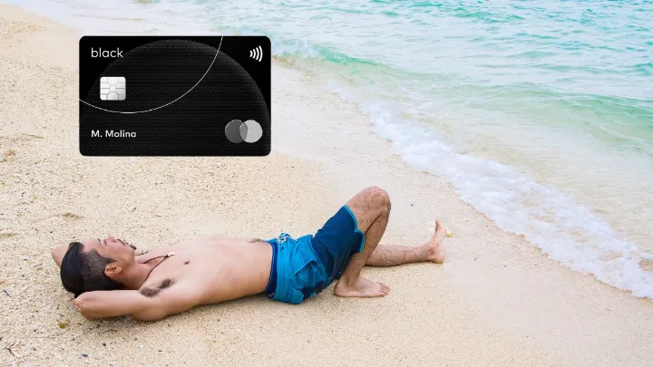 Homem deitado na areia de uma praia com um cartão preto Mastercard Black ilustrado ao lado.